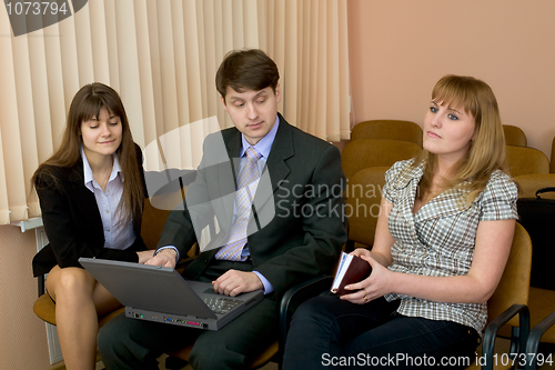 Image of Group of businessmen sitting on armchairs