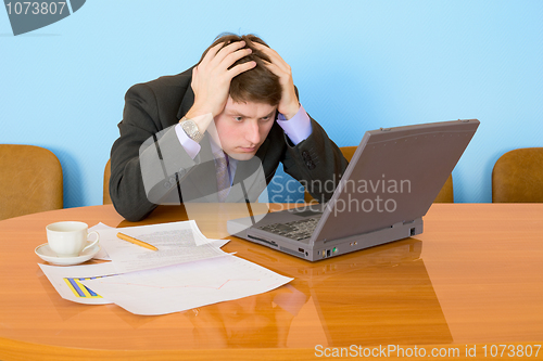 Image of Businessman on a workplace with the laptop