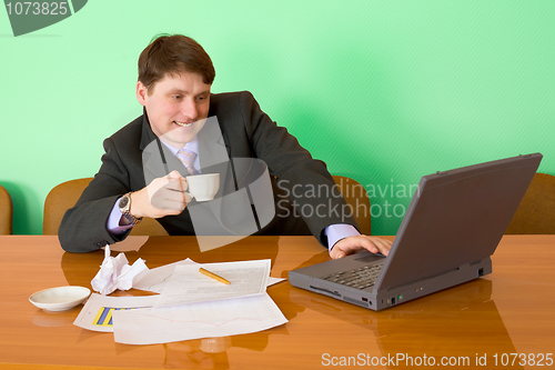 Image of Businessman on a workplace with the laptop