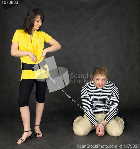 Image of Guy chained in a chain and girl