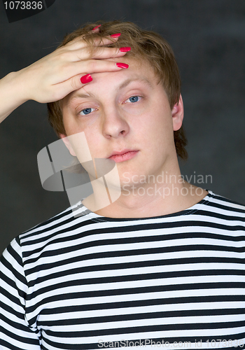 Image of Man with female hand on his forehead