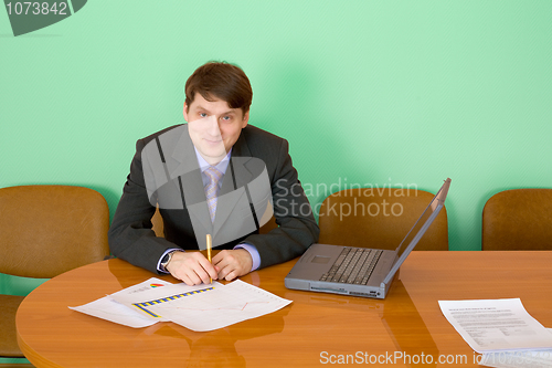 Image of Businessman at a table with laptop