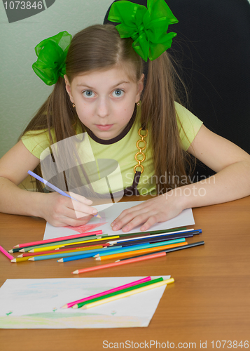 Image of Girl drawing sitting at a table
