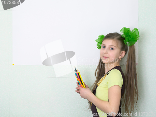 Image of Girl with color pencils and a sheet of paper