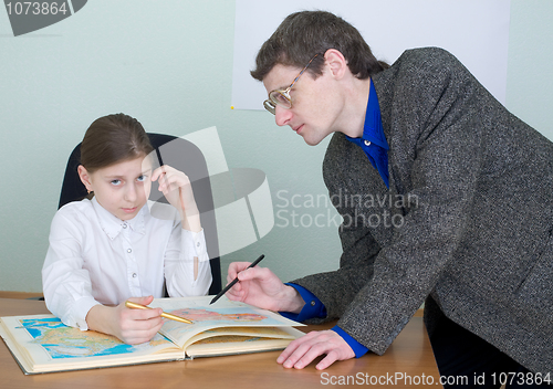 Image of Tutor and schoolgirl with atlas