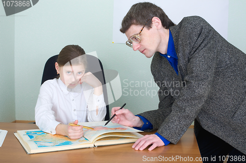 Image of Tutor and schoolgirl with atlas