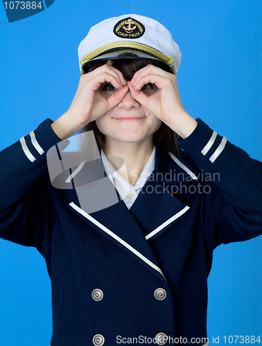 Image of Girl in a sea uniform emits binoculars