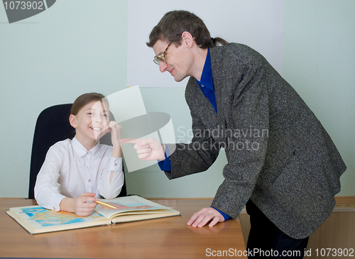 Image of Tutor and schoolgirl with atlas