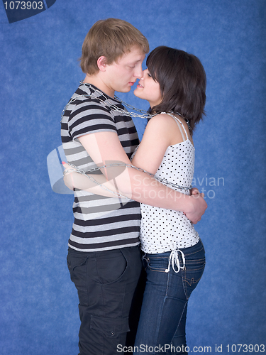 Image of Loving couple chained by a chain