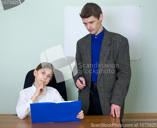 Image of Teacher and schoolgirl with book