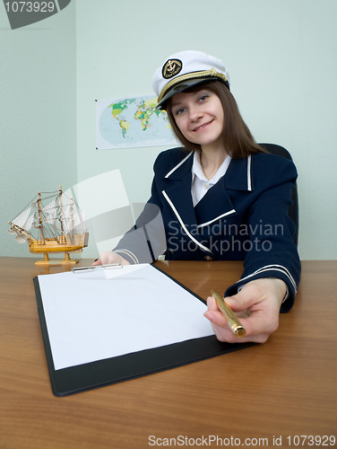 Image of Woman in a sea uniform at table with tablet