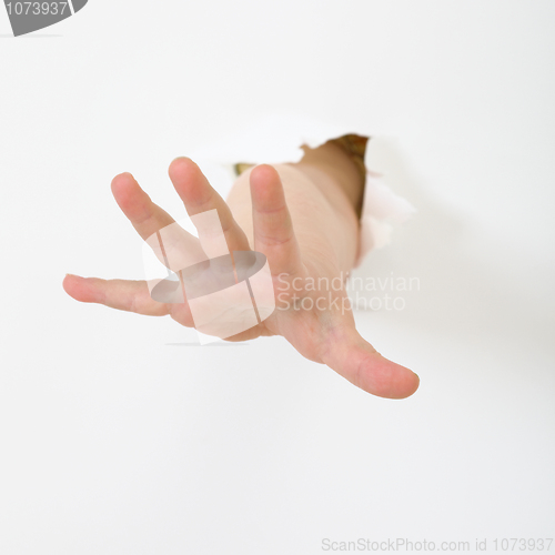 Image of Child's hand stick out from hole