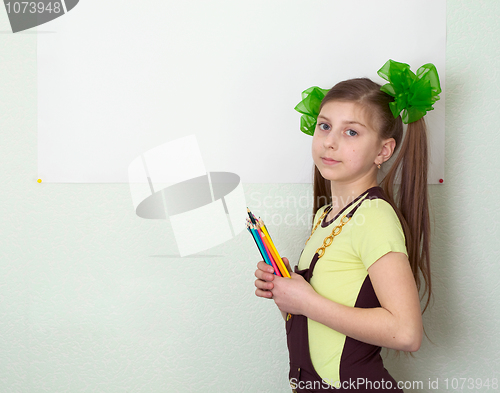 Image of Girl with color pencils and a sheet of paper