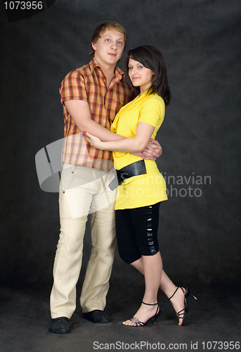 Image of Couple embraces on a black background