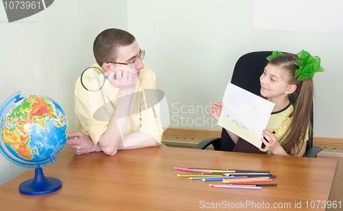 Image of Girl shows new drawing to the brother