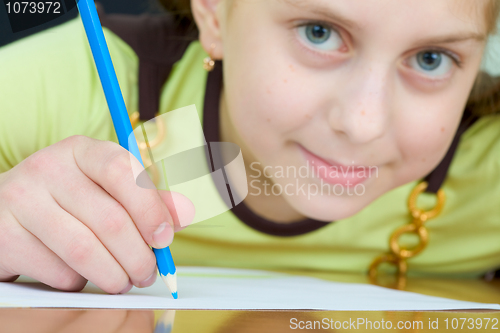 Image of Girl holding a blue pencil