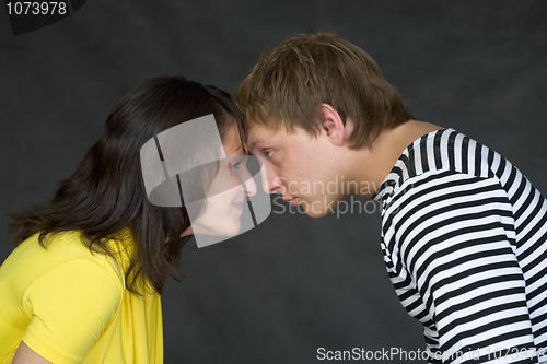 Image of Guy and the girl have faced foreheads on a black