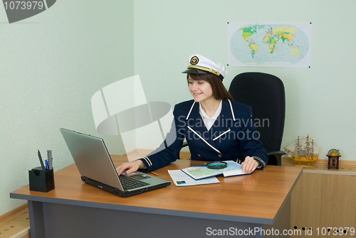 Image of Portrait of the girl in a sea uniform at a table