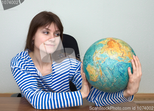 Image of Woman in a stripped vest with globe