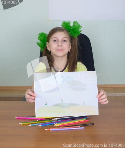 Image of Smiling girl shows new drawing to us