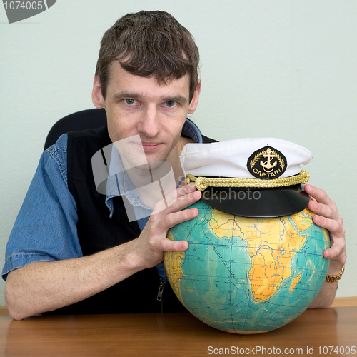 Image of Man with the globe and a cap