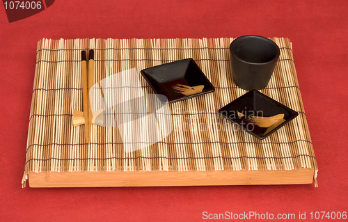 Image of Still life from tray with chinese stick's and sauce-boat