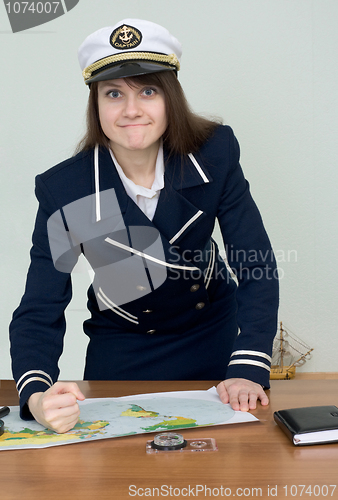 Image of Woman in a sea uniform at table with map