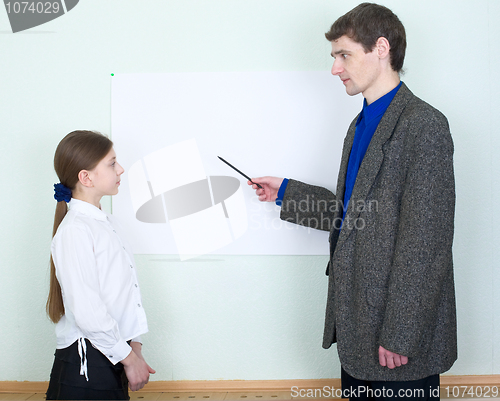 Image of Teacher explains something to the schoolgirl