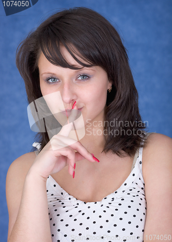 Image of Mysterious girl with a finger near lips