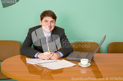 Image of Businessman on a workplace with the laptop