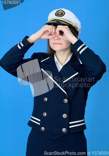 Image of Girl in a sea uniform emits binoculars