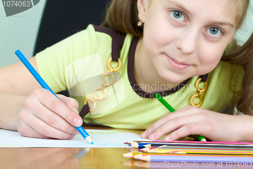Image of Girl holding a blue pencil