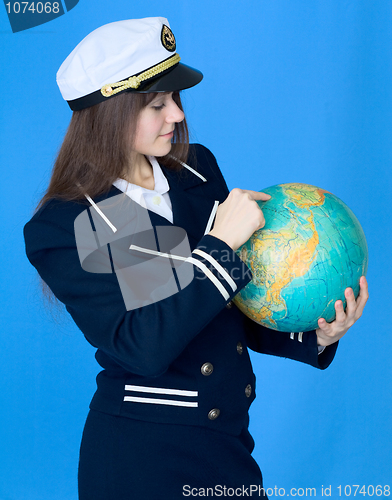 Image of Woman in sea uniform and globe