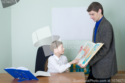 Image of Tutor and schoolgirl with atlas