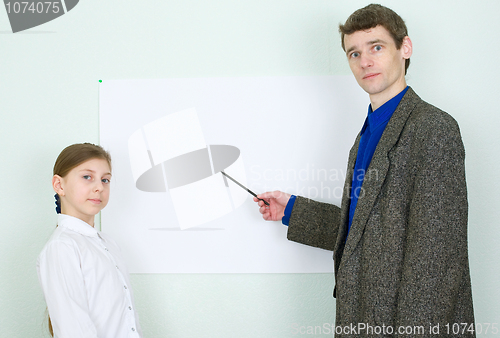 Image of Teacher explains something to the schoolgirl