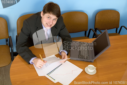 Image of Businessman on a workplace with the laptop