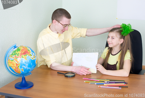 Image of Girl shows new drawing to the brother