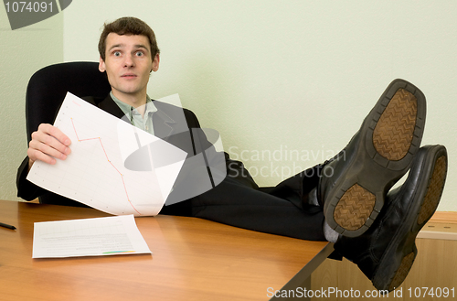Image of Director on a workplace with a graph