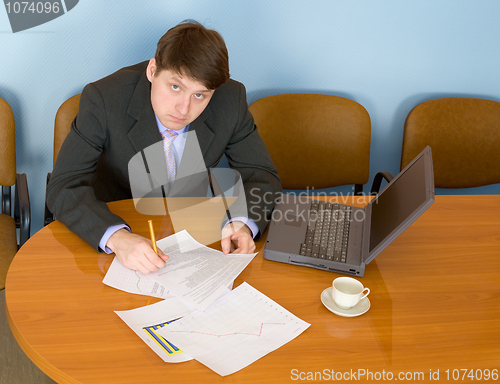 Image of Businessman on a workplace with the laptop