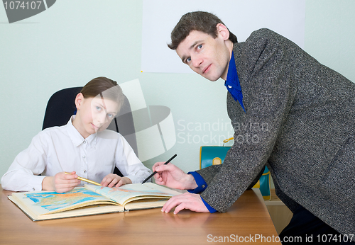 Image of Tutor and schoolgirl with atlas