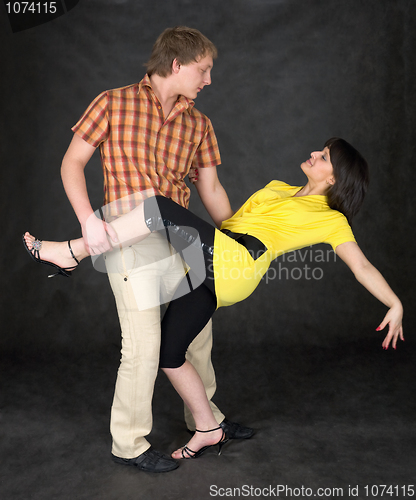 Image of Couple dancing a tango on a black