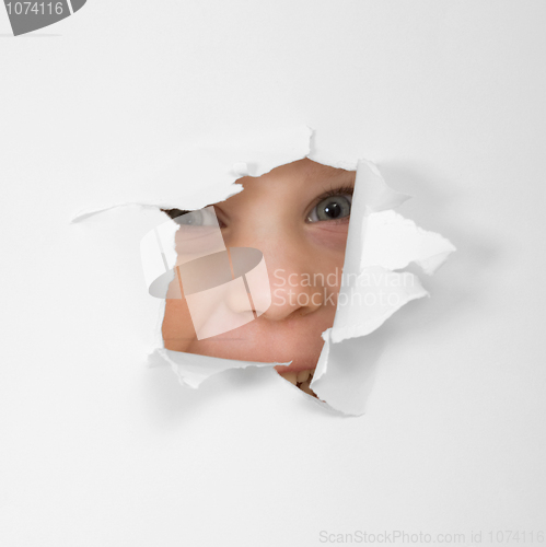 Image of Eye looking through hole in sheet of paper