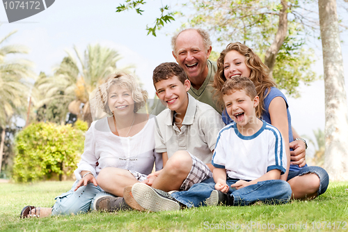 Image of Happy family having fun in the park