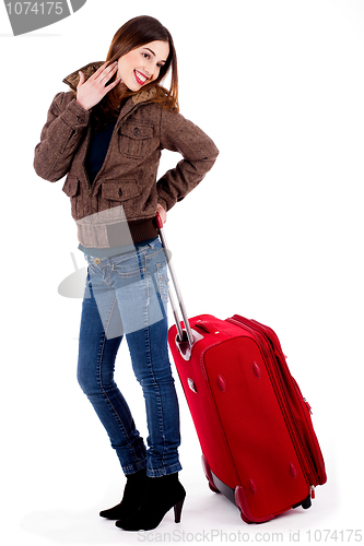 Image of young lady posing with luggage