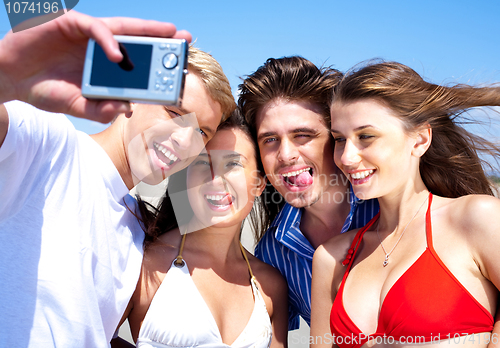 Image of Friends taking self portrait, outdoors
