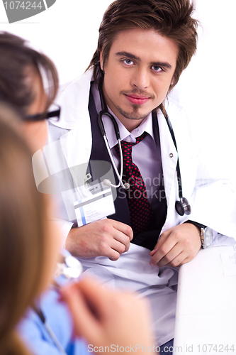 Image of Young doctor sitting with hospital staff