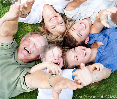 Image of Happy family lying as a circle