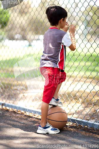 Image of Rear view of young basketball player