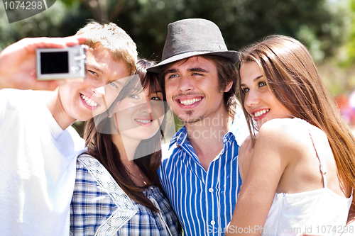 Image of Friends taking self portrait, outdoors