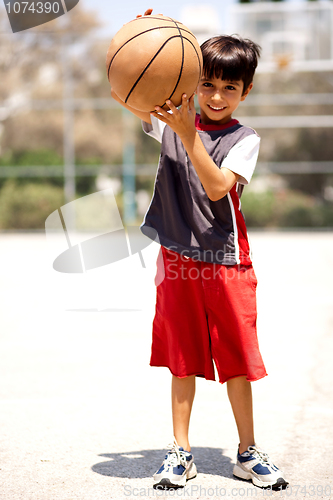 Image of Adorable boy with basketball